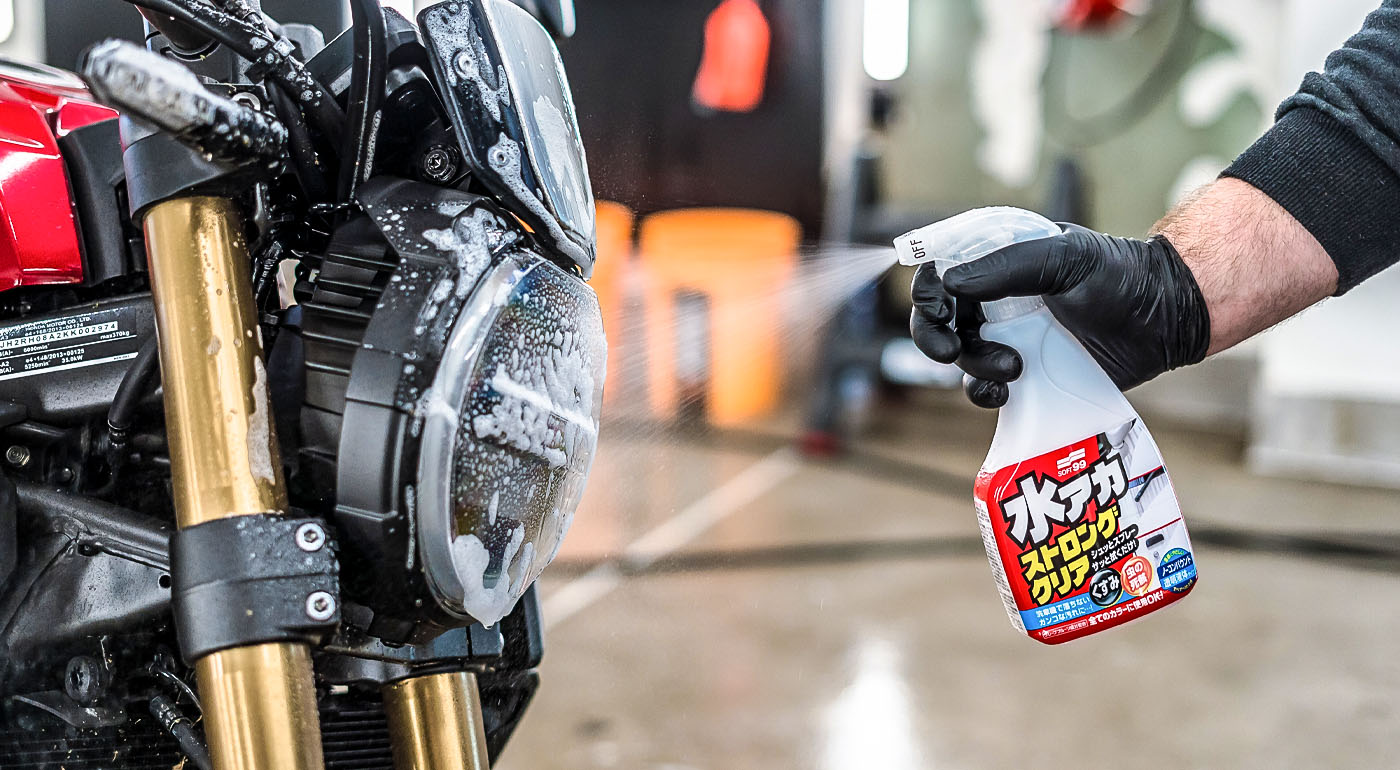 Soft99 car care product Stain Cleaner being sprayed on a motorcycle.